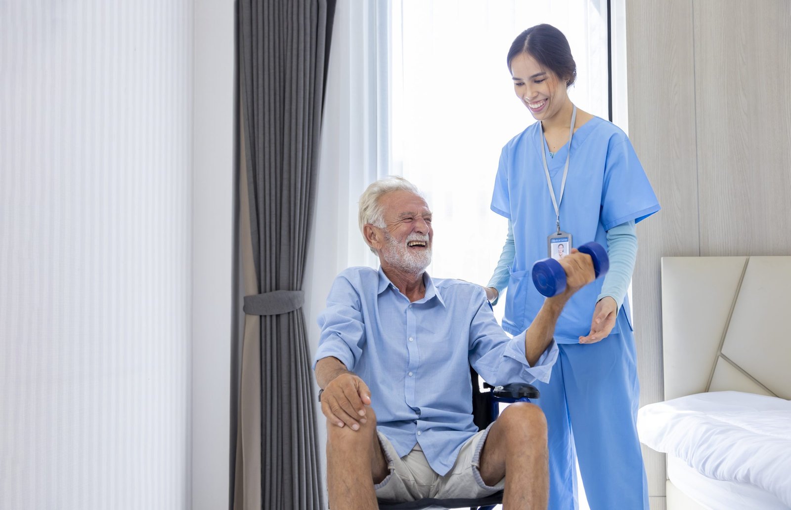 A nurse helping a man seated in a wheelchair with strength exercises.